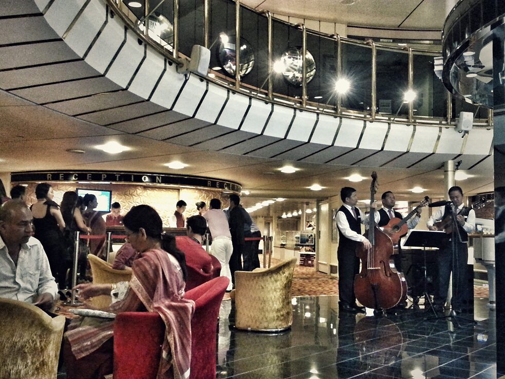 An all-Filipino guitar trio performs at the lobby of a cruise ship sailing from Penang, Malaysia to Phuket, Thailand in 2013. 