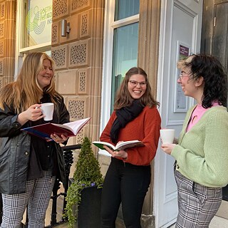 Visitors having a coffee break at the entrance of the Institute