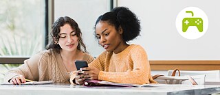 Two young women looking at a smartphone together.