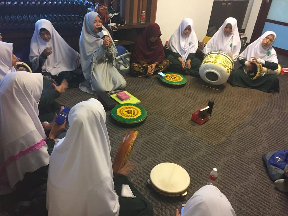 Nengsih Suprihatin (with microphone) leading domestic worker members of the Nur Assyifa Islamic chant (nashid) group at a mosque in the Novena area, Singapore. 
