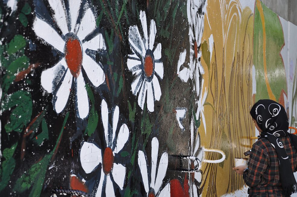Die Graffiti-Künstlerin Shamsia Hassani bemalt eine Wand.