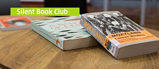 Silent Book Club banner with 2 South African books on a table