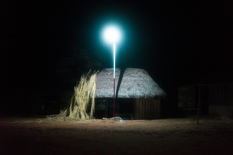 A hut is lit by solar powered lamps in Sarayaku’s central plaza. 