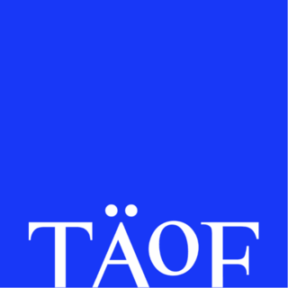 Colorful background with a white serif wordmark reading TÄOF. The lettering is enlarged and partially cropped at the bottom of the image.
