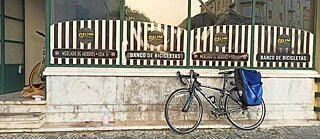 A bike is parked infront of a store in Lisbon
