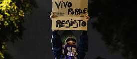 During a demonstration for the decriminalisation of abortion in Argentina, a protester lifts a sign that reads “I live because I resist.” 