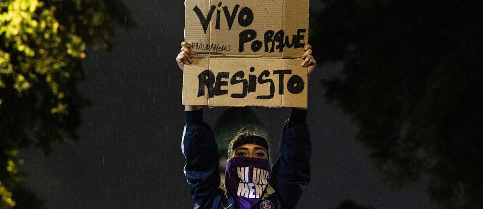 During a demonstration for the decriminalisation of abortion in Argentina, a protester lifts a sign that reads “I live because I resist.” 