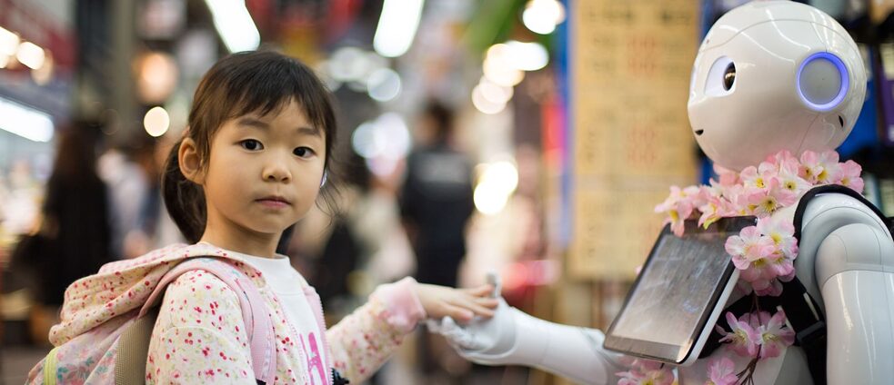 Kind mit Roboter auf dem Kuromon-Markt in Osaka, Japan