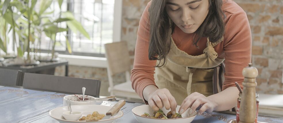 Cafe Mango Sameera begins plating the dish