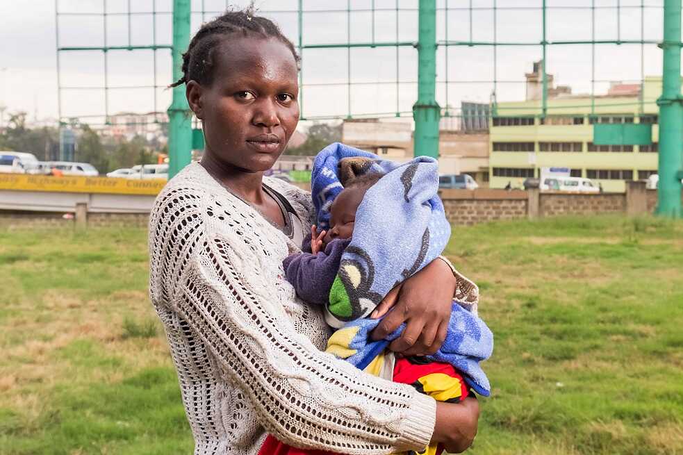 Mary with her two months old child in her arms