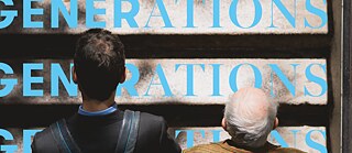 A young and an old man standing next to each other