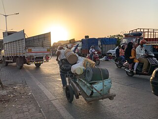 At the end of the day, a man pulls his cart containing waste plastic and metal down the road close to the Acorn Foundation. 