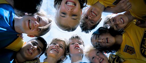 To Far Away - film still: a group of kids look at the camera from bird's eye perspective