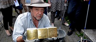 The artist Gunter Demnig at a Stumbling Stone laying ceremony 