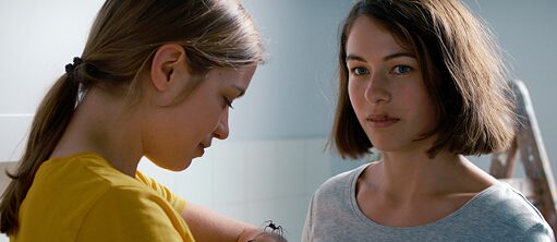 The Girl and the Spider - film still: two young women look at a spider