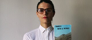 A photo of Anahita Razmi with a book