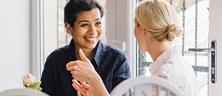 Two women chat which each other