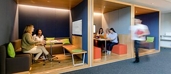 Various people sitting in separate seating areas.