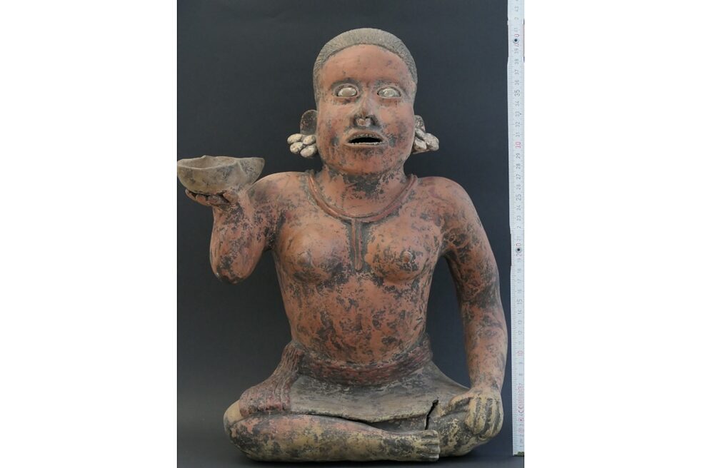 Clay sculpture of a seated character