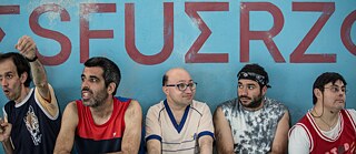 Cinq hommes en maillots assis