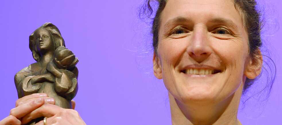 Martina Wildner at the 2014 Deutscher Jugendliteraturpreis (German Young Adult Literature Prize) award ceremony holding the “Momo” trophy. 