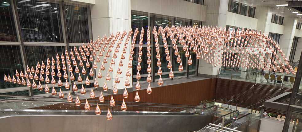 The “Kinetic Rain” sculpture is meant to add a contemplative element to the lively transit space of Singapore’s Changi Airport departure hall: The 608 copper-plated aluminum drops are connected to computer-controlled motors that slowly move up and down individually.