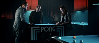 Arrêt sur image de la série Netflix "The Billion Dollar Code" : Carsten, Juri et l'avocate Lea jouent une dernière fois au pong dans un bar après l'annonce du verdict.