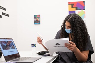 Alison Beshai of Form Function Studio reviewing Gaither’s work samples during An Evening of Design & Conversation, MLK Library, October 2021 