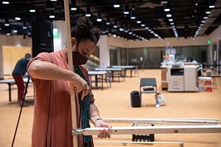 Valoris assembling her structure in the Labs at DC Public Library during An Evening of Design and Conversation, MLK Library, October 2021