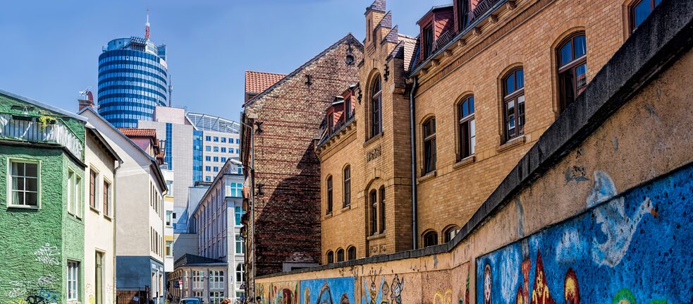 Graffiti and industrial buildings in front of the Zeiss Tower.
