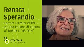 Photo of Renata Sperandio, from the shoulders, looking to the left, grey hair, wearing glasses with a red frame