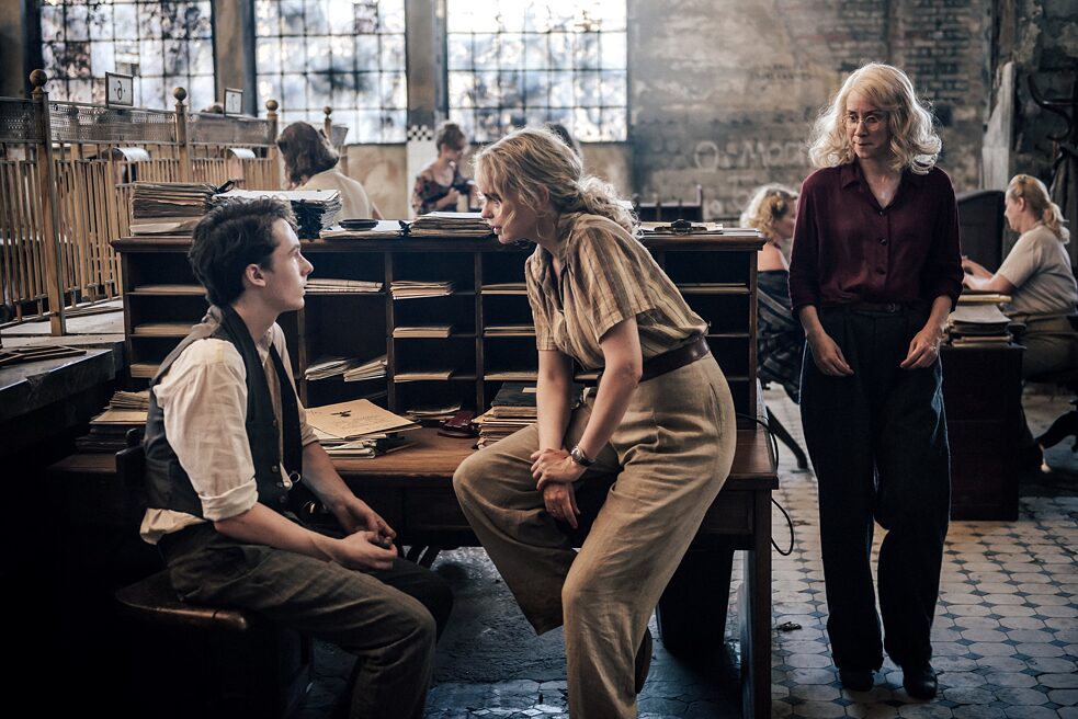 Trude (Lena Dörrie, right) watches Gad (Maximilian Ehrenreich, left) and Elsie (Nina Hoss, middle) in a passionate argument.