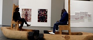 Ivory Coast's artist Jems Koko Bi sits with Senegalese artist Soly Cisse at the exhibition “Prete-moi ton reve” in Dakar, Senegal.