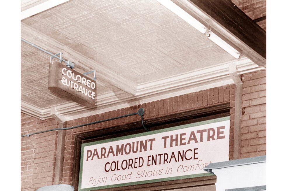 Racism – Separate entrance for “coloured” people in a Paramount movie-theatre, USA 1930, Photo; digital colourisation. 