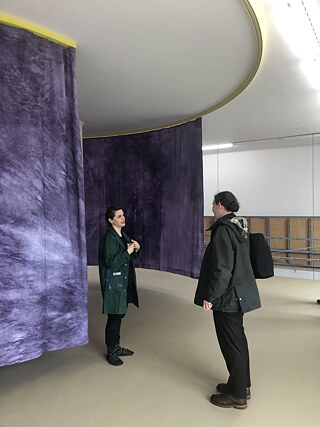 Ruth Buchanan with her work 'Spiral Time', 2022, in conversation with the artist Sandra Knecht during the construction process in Kunstmuseum Basel | Gegenwart. 