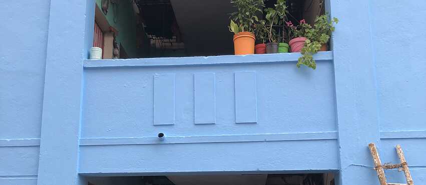 The Chennai mural wall is given a layer of base paint in blue.
