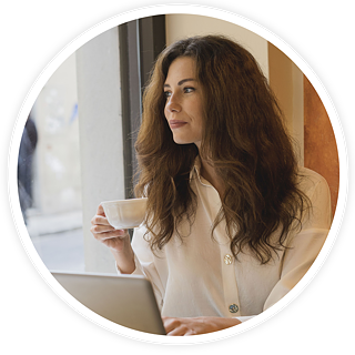 woman working at a laptop in a cafe