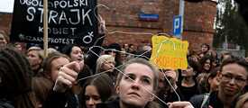 Women dressed in black protest on the street    