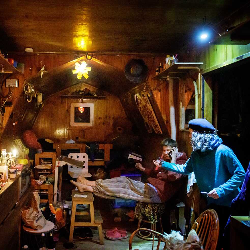 Residents inside a trailer at Wagenburg Lohmühle in Berlin