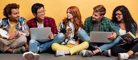 junge leute sitzen zusammen mit laptops