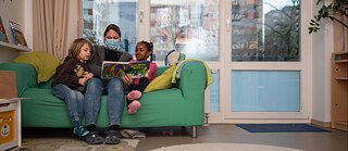 A kindergarten teacher reads to children.