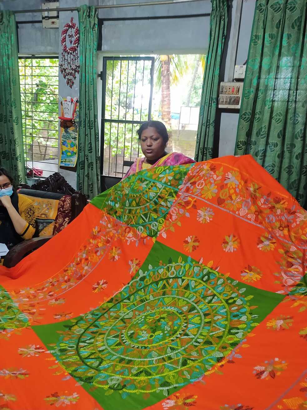 Lily showcasing her artisan made nakshi kantha bedsheet.   			
