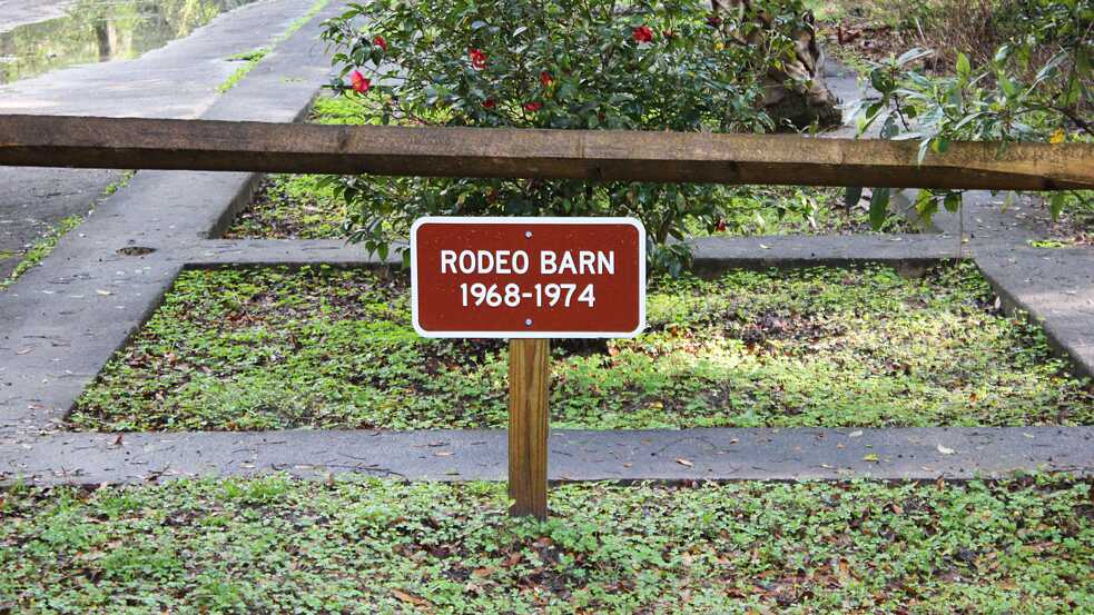 Ruins of the rodeo at Rainbow Springs with a sign reading “rodeo barn 1968–1974”