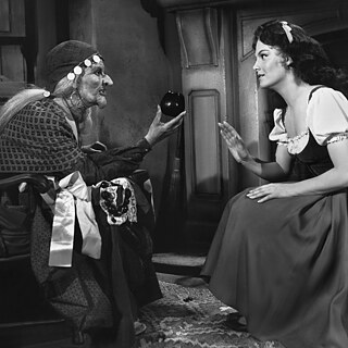 A black and white film still, on the right you see the witch handing Snow White, sitting on the left, an apple.