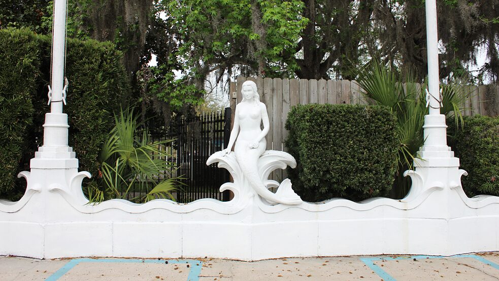 A white mermaid sculpture outside the entrance of Weeki Wachee Springs State Park