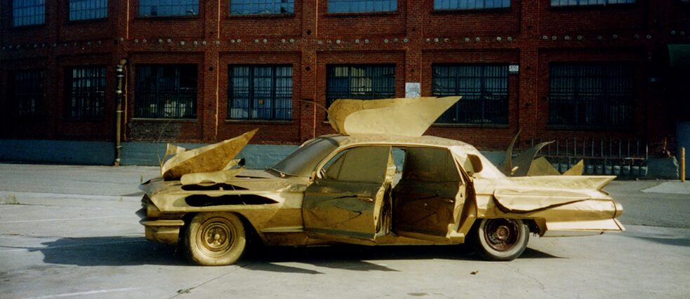A golden Cadillac with Wings