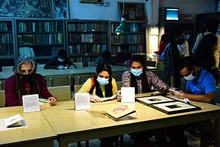   Audience interacting with the books at the Seminar Library