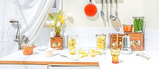 A kitchen countertop with preserved goods on it