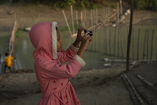   A workshop participant is practicing with her new camera 