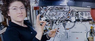 ISS Astronaut Christina Koch installing a new piece of hardware for the Cold Atom Lab, an experimental physics facility that chills atoms to almost absolute zero (0 degrees kelvin, - 459 degrees Fahrenheit)